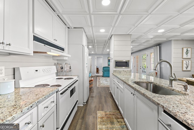 kitchen featuring dark wood-type flooring, white cabinetry, stainless steel appliances, sink, and light stone counters