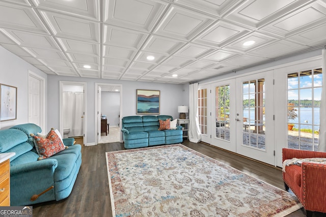 living room with a water view, french doors, and dark hardwood / wood-style flooring