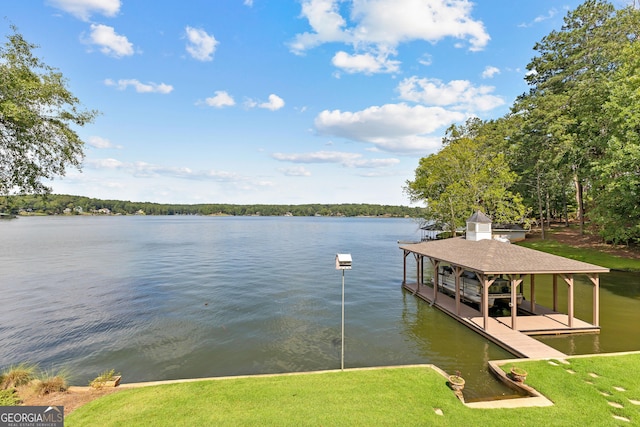 view of dock featuring a water view and a lawn