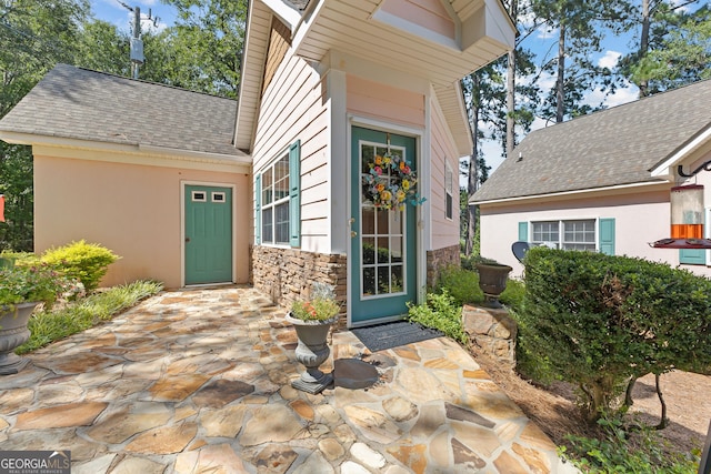 property entrance featuring a patio