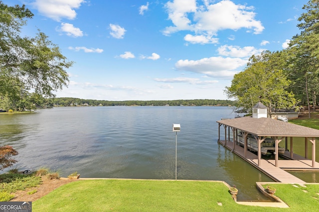 dock area featuring a lawn and a water view