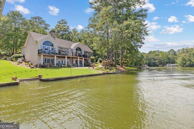 exterior space featuring a yard and a water view