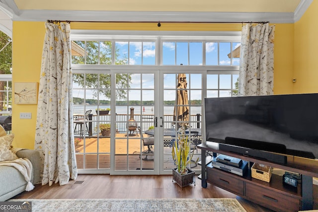 living room with crown molding and hardwood / wood-style flooring