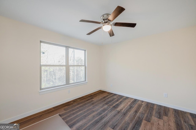 unfurnished room with ceiling fan and dark hardwood / wood-style floors