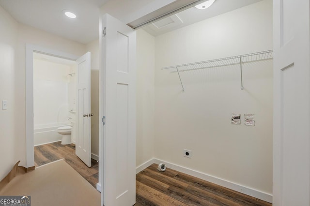 clothes washing area with electric dryer hookup and dark hardwood / wood-style floors