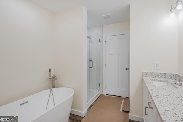 bathroom with vanity and independent shower and bath