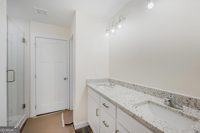 bathroom featuring vanity and a shower with shower door