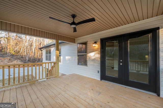 wooden deck featuring ceiling fan and french doors