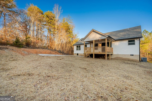 rear view of house with central AC, ceiling fan, and a wooden deck