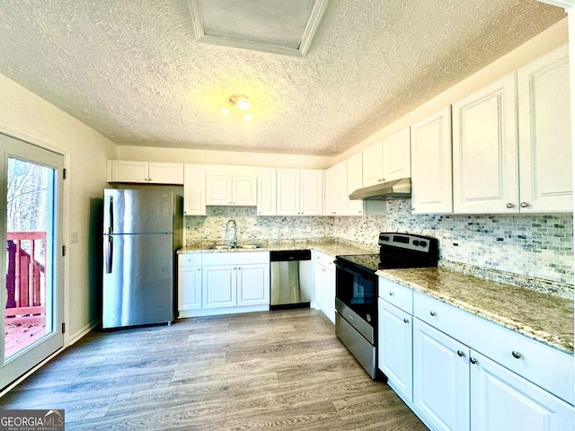 kitchen with stainless steel appliances, white cabinetry, and sink