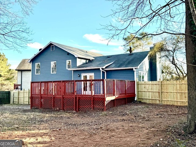 rear view of property featuring a wooden deck