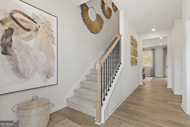 stairway featuring wood-type flooring