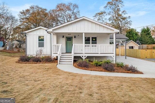 view of front of home featuring covered porch and a front yard