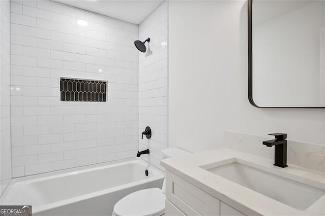 full bathroom featuring toilet, vanity, and tiled shower / bath combo