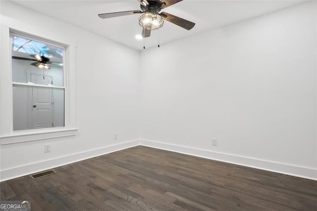 spare room with dark hardwood / wood-style flooring