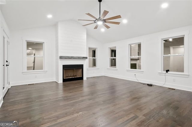 unfurnished living room featuring a fireplace, dark hardwood / wood-style flooring, and lofted ceiling