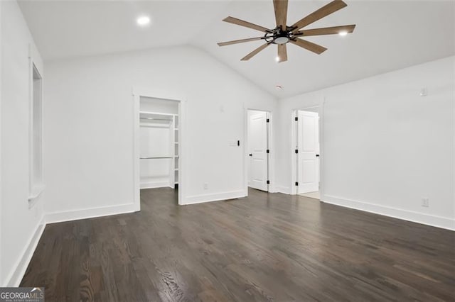 unfurnished bedroom featuring a walk in closet, ceiling fan, dark hardwood / wood-style floors, a closet, and lofted ceiling