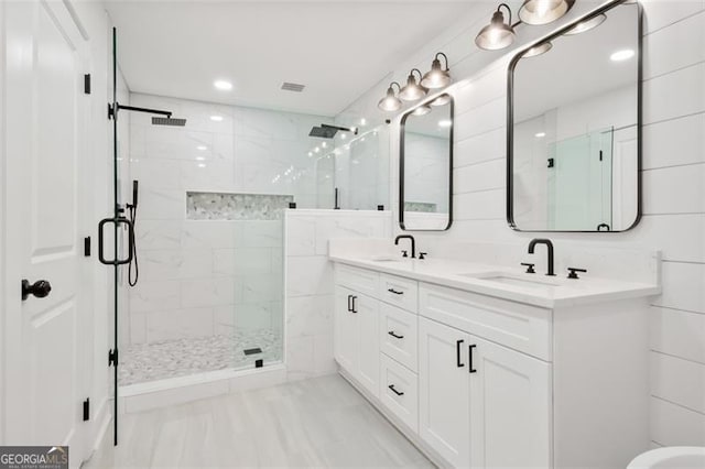 bathroom featuring tile patterned floors, vanity, and a shower with shower door