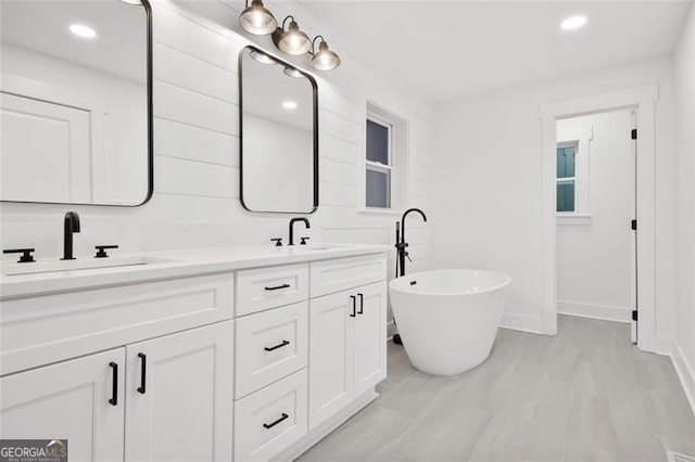 bathroom featuring a bathing tub and vanity