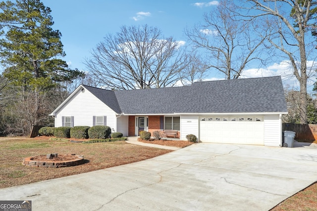 ranch-style house featuring a garage and a front lawn