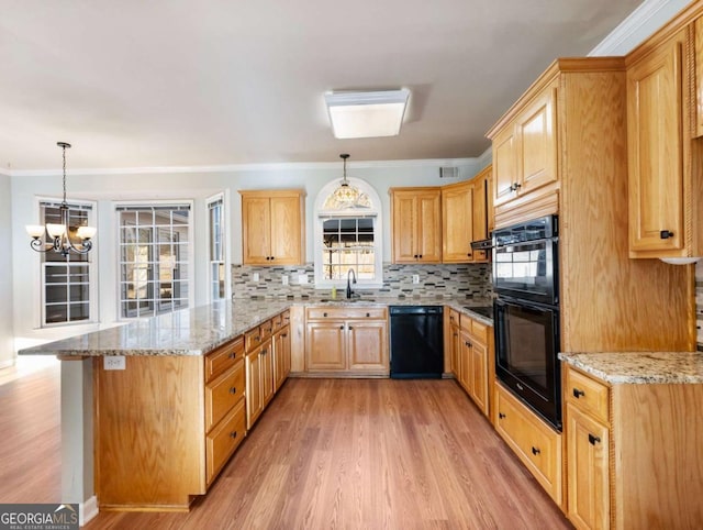 kitchen with backsplash, black appliances, light stone countertops, decorative light fixtures, and a chandelier