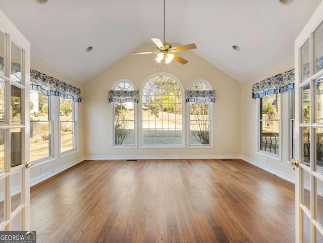 unfurnished sunroom with ceiling fan and lofted ceiling