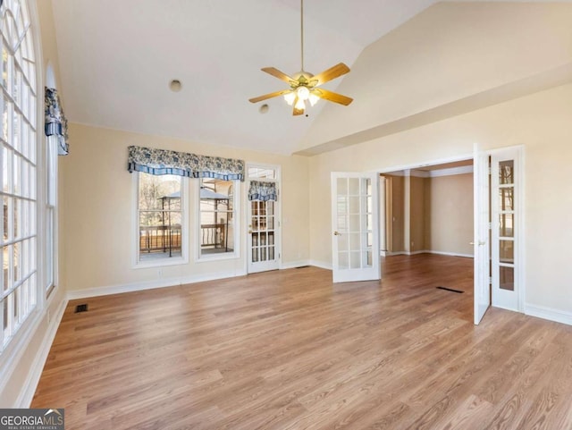 interior space featuring ceiling fan, french doors, light hardwood / wood-style floors, and vaulted ceiling