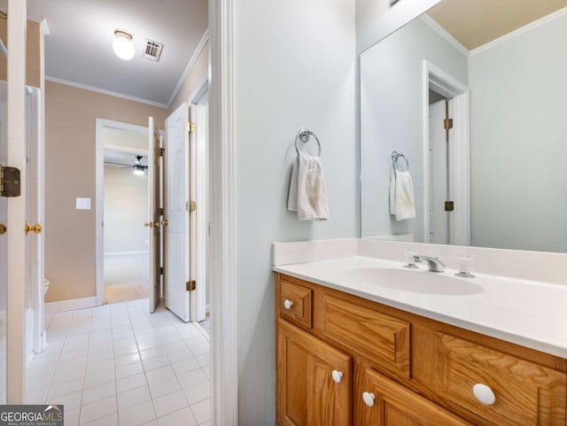 bathroom with crown molding, tile patterned flooring, and vanity