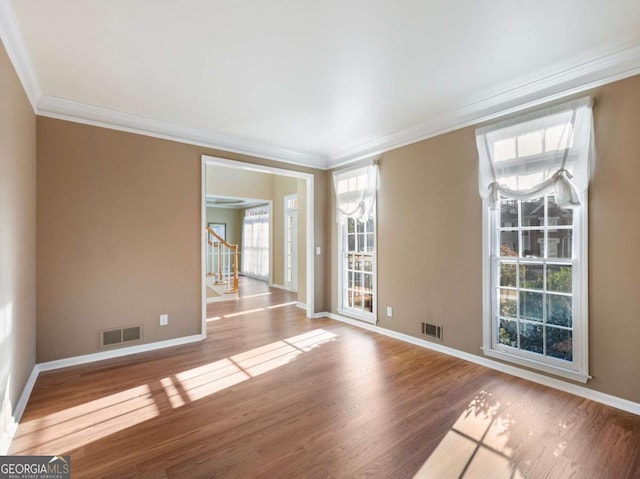 unfurnished room with wood-type flooring and ornamental molding