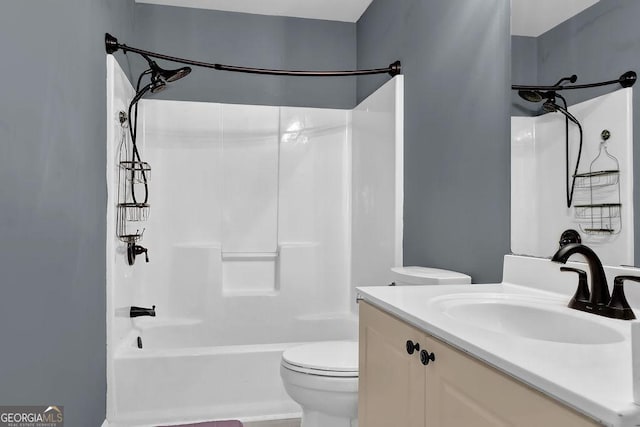 full bathroom with bathtub / shower combination, vanity, and toilet