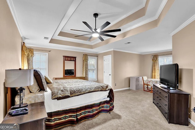 carpeted bedroom featuring ceiling fan, a raised ceiling, and ornamental molding