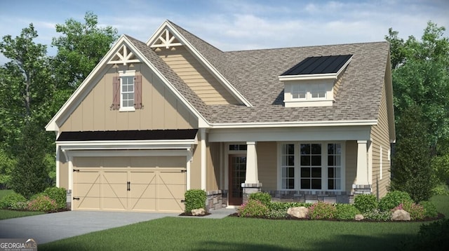 craftsman-style home with covered porch, a garage, and a front lawn