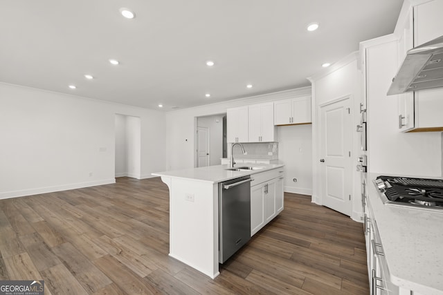 kitchen featuring wall chimney exhaust hood, stainless steel appliances, sink, white cabinetry, and an island with sink