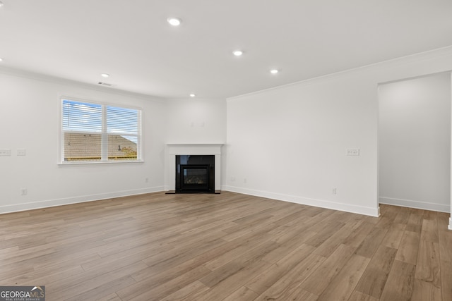 unfurnished living room featuring light hardwood / wood-style floors and ornamental molding