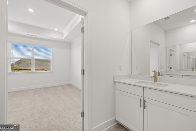 bathroom featuring vanity, a tray ceiling, and crown molding