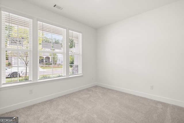 unfurnished room with light carpet