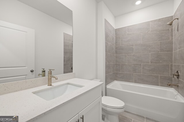 full bathroom with tile patterned flooring, vanity, toilet, and tiled shower / bath