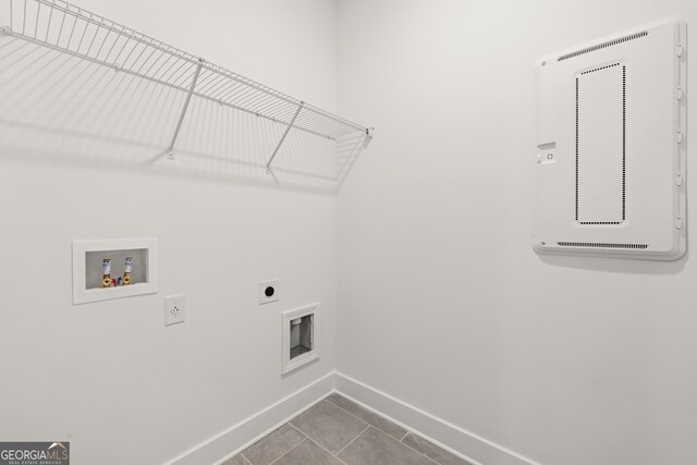 laundry area featuring electric dryer hookup, tile patterned floors, and washer hookup