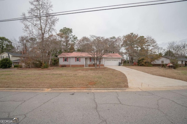 single story home with a garage and a front yard