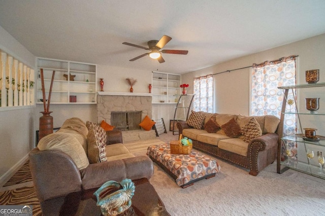 living room with ceiling fan and a fireplace