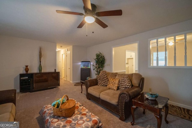 carpeted living room with ceiling fan