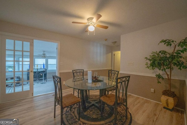 dining area with ceiling fan, light wood-type flooring, and french doors