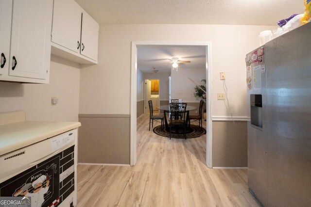 kitchen with white cabinets, stainless steel refrigerator with ice dispenser, light hardwood / wood-style flooring, and ceiling fan