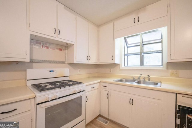 kitchen with sink, white cabinets, and white gas range oven