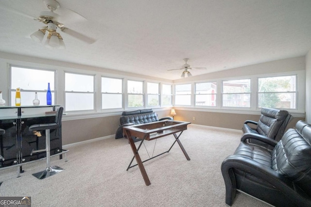 carpeted living room featuring ceiling fan and indoor bar