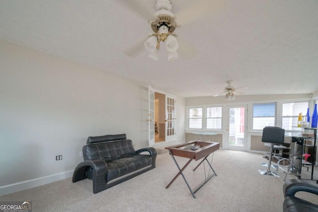 office space with a textured ceiling, ceiling fan, light carpet, and french doors