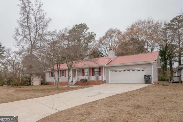 ranch-style house with covered porch, a garage, and a front lawn