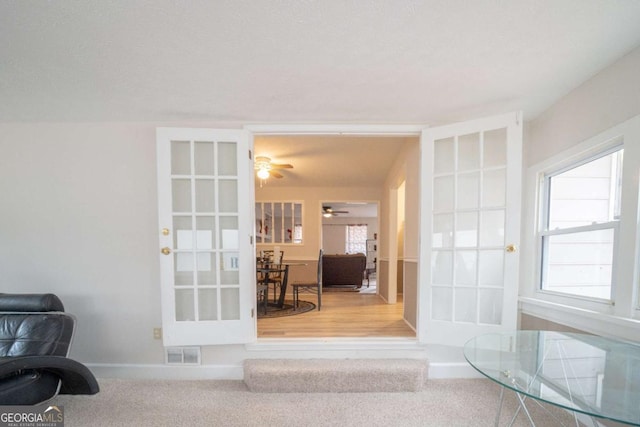 interior space with carpet flooring, a wealth of natural light, and ceiling fan