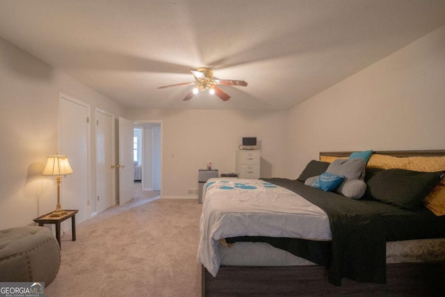 bedroom with ceiling fan and light colored carpet