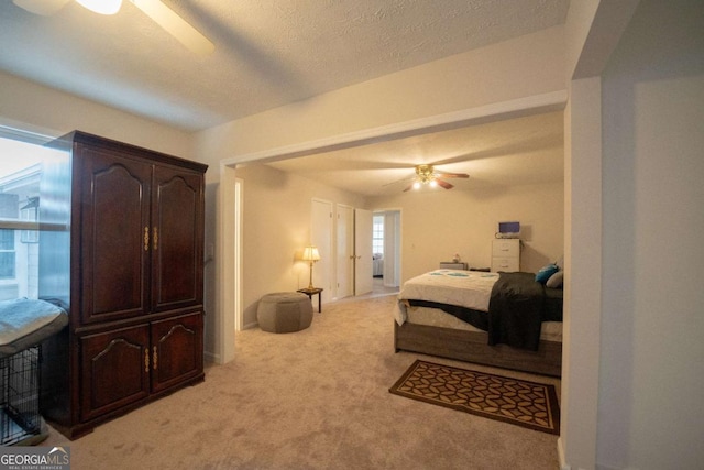 carpeted bedroom with a textured ceiling and ceiling fan